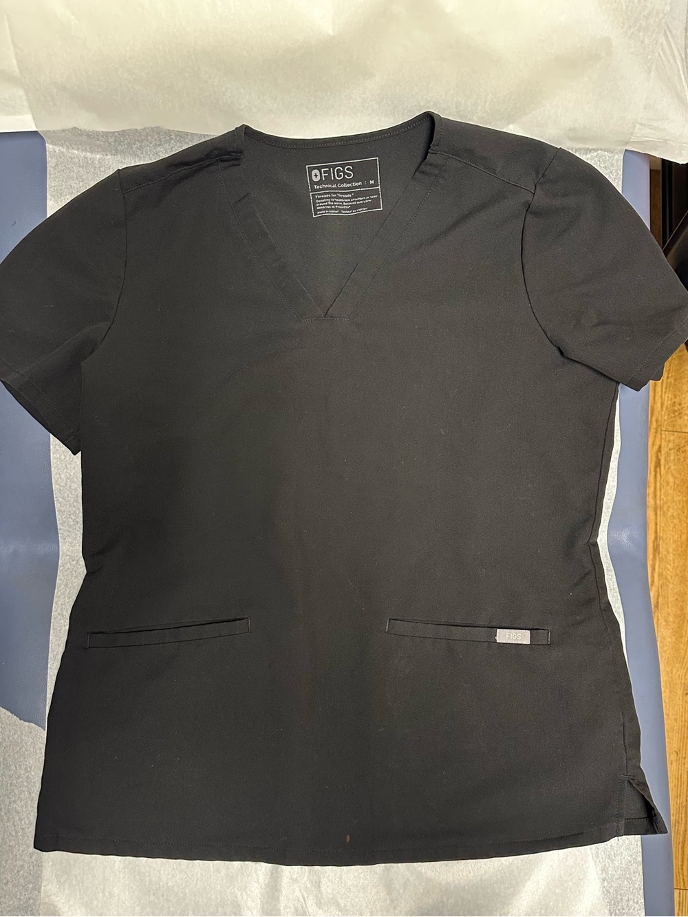 Figs Black Casma 3 pocket scrub top. Medium. Small stain on bottom on top.
